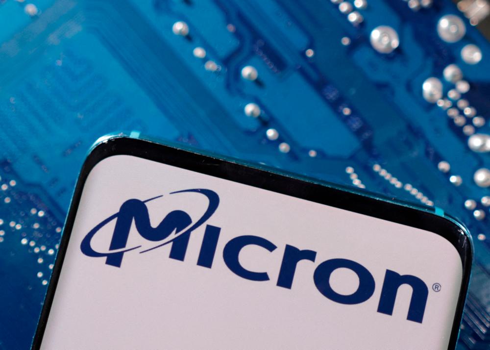 A smartphone with a displayed Micron logo is placed on a computer motherboard in this illustration. – Reuterspic