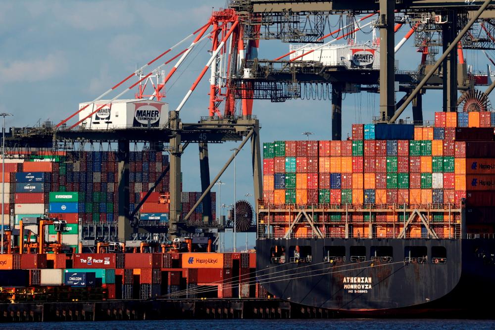 Shipping containers are unloaded on a pier at Port Newark, New Jersey. US economic growth is slowing, Goldman Sachs CEO David Solomon says. – Reuterspic