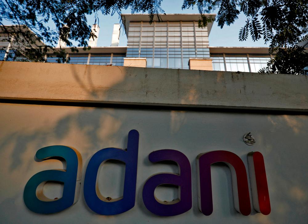 The logo of the Adani Group is seen on the wall of its realty office building on the outskirts of Ahmedabad, India. – Reuterspic