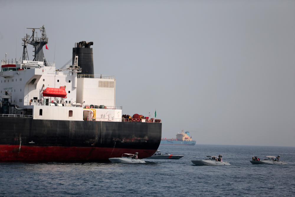 UAE Navy boats are seen next to the Saudi tanker Al Marzoqah off the Port of Fujairah, UAE, May 13, 2019. - Reuters