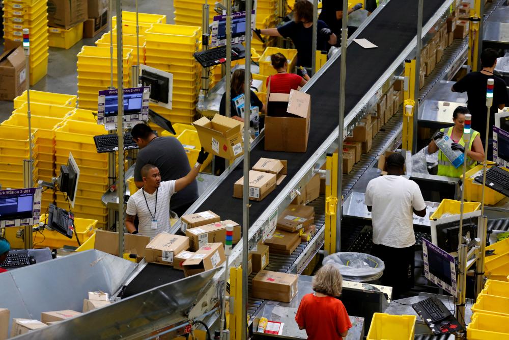 File picture of workers sorting arriving products at an Amazon Fulfilment Center in Tracy, California. – Reuterspic