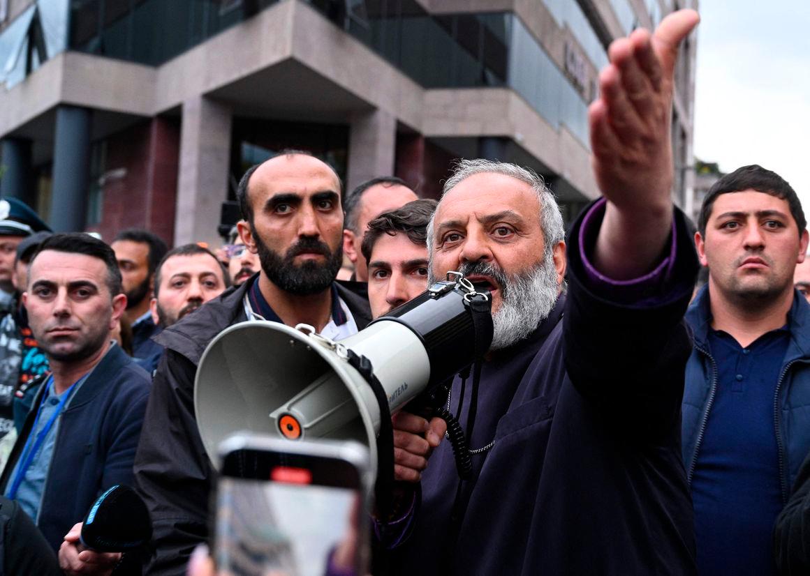 Protest leader Archbishop Bagrat Galstanyan addresses demonstrators during a protest against land transfer to neighbouring Azerbaijan, in Yerevan on May 15, 2024. (Photo by KAREN MINASYAN / AFP)