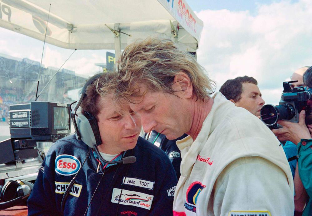 In this file photo taken on June 22, 1991 Peugeot Talbot Sport manager Jean Todt (L) talks to French Jean-Pierre Jabouille (C), one of the drivers of the Peugeot Talbot Sport 905 N°5, 6 hours after the start of the 59th edition of the 24 hours of Le Mans, on the circuit de la Sarthe in Le Mans, western France, while the Peugeot 905s are no longer in the race after retirement for mechanical problems/AFPPix