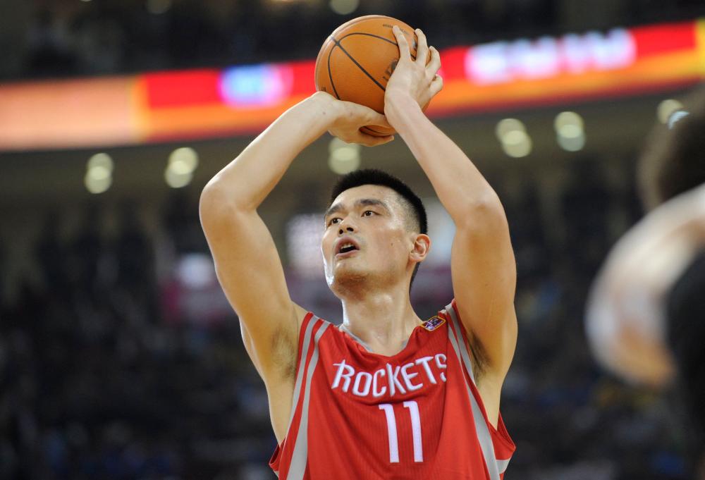 (FILES) In this file photo taken on October 13, 2010, Houston Rockets All-Star Yao Ming takes a penalty shot during their match against the New Jersey Nets in the NBA China Games 2010 basketball match at the Wukesong Arena in Beijing. AFPPIX