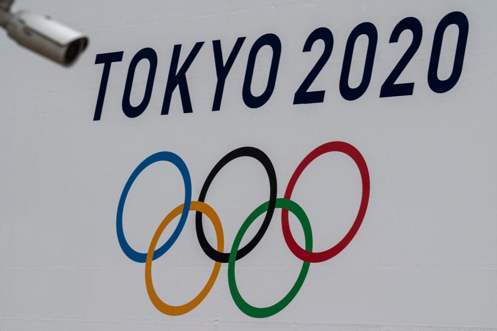 (FILES) File photo taken on April 13, 2021 of a Tokyo 2020 Olympics Games banner displayed on the wall of the Metropolitan Government building in Tokyo.-AFP
