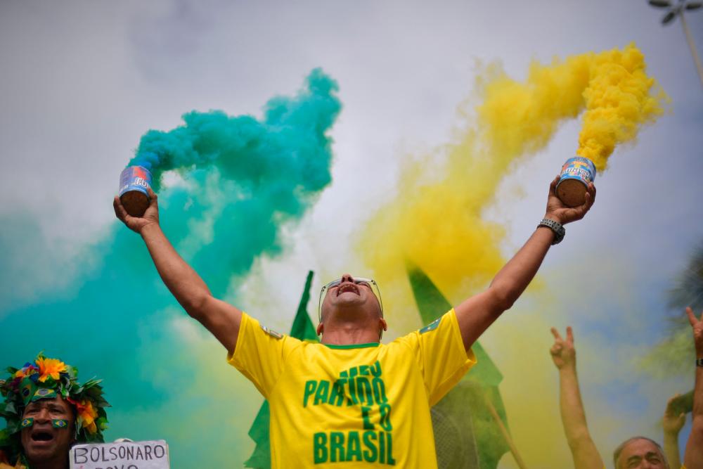 (FILES) In this file photo taken on October 28, 2018, a supporter of far-right lawmaker and presidential candidate for the Social Liberal Party (PSL), Jair Bolsonaro, takes part in a pro-Bolsonaro demonstration in Rio de Janeiro, Brazil, during the second round of the presidential elections. AFPPIX