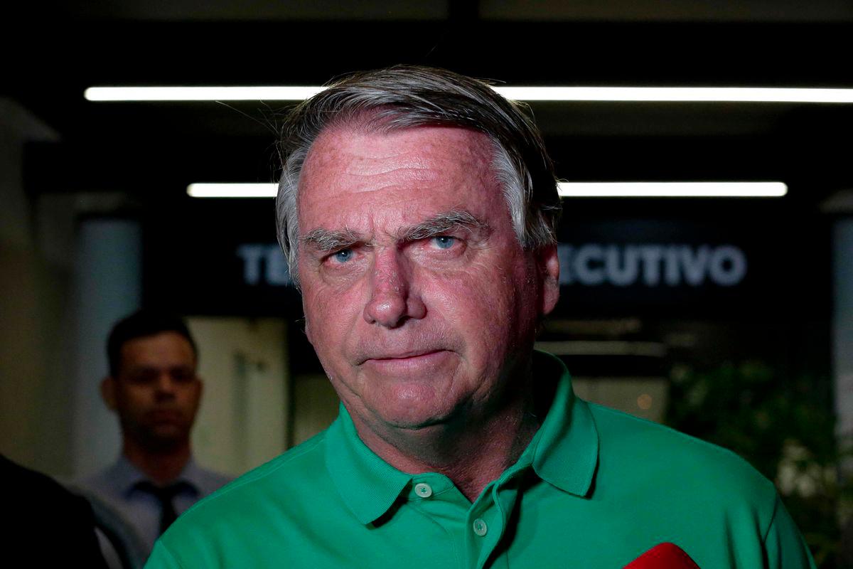 Former Brazilian President (2019-2022) Jair Bolsonaro gestures during a press conference about his defense in the Supreme Court case on acts against Brazilian democracy on January 8, 2023, on arrival at Brasilia airport on March 6, 2025. - AFPPIX