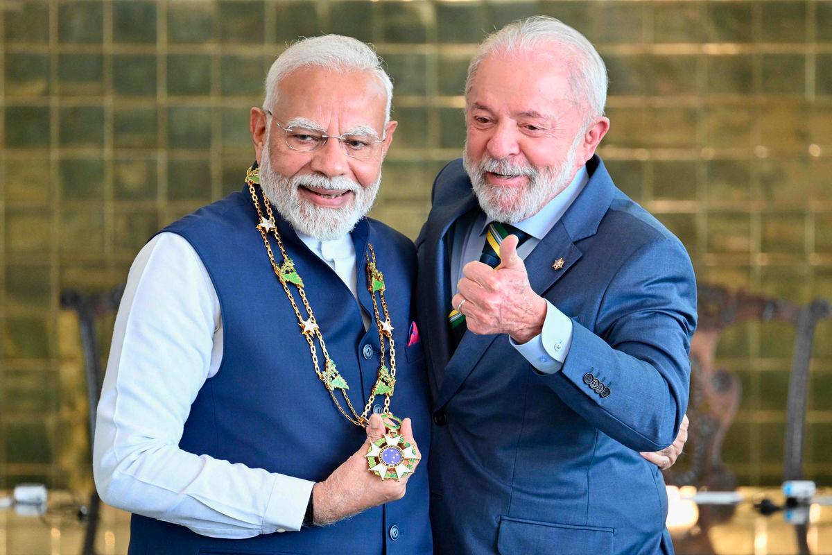 India's Prime Minister Narendra Modi (L) receives the National Order of the Southern Cross from Brazil's President Luiz Inacio Lula da Silva following a press statement at Alvorada Palace in Brasilia on July 8, 2025. - AFPPIX
