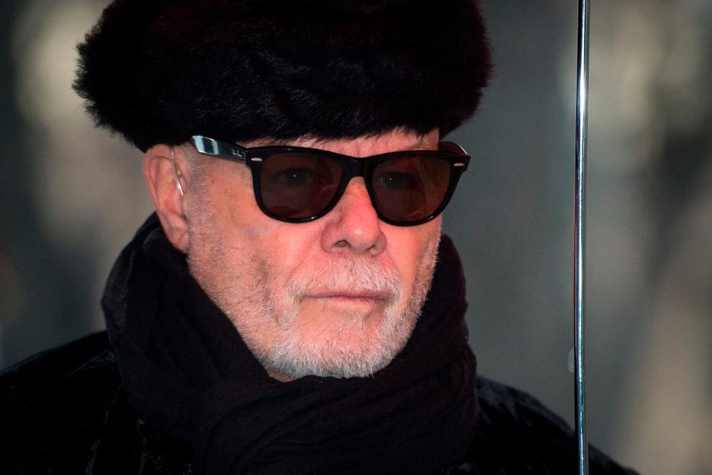 (FILES) In this file photo taken on February 5, 2015 British former pop star Gary Glitter, whose real name is Paul Gadd, arrives at Southwark Crown Court in central London during his trial on 10 charges related to sex crimes between 1975 and 1980. AFPPIX