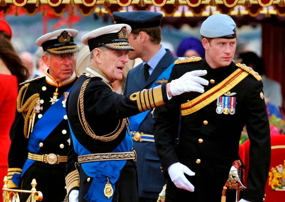(FILES) In this file photo taken on June 03, 2012 Members of the Royal family (from left to right) Prince Charles, Prince of Wales, Prince Philip, Duke of Edinburgh, Prince William and Prince Harry talk onboard the Spirit of Chartwell during the Thames Diamond Jubilee Pageant on the River Thames in London. - AFP