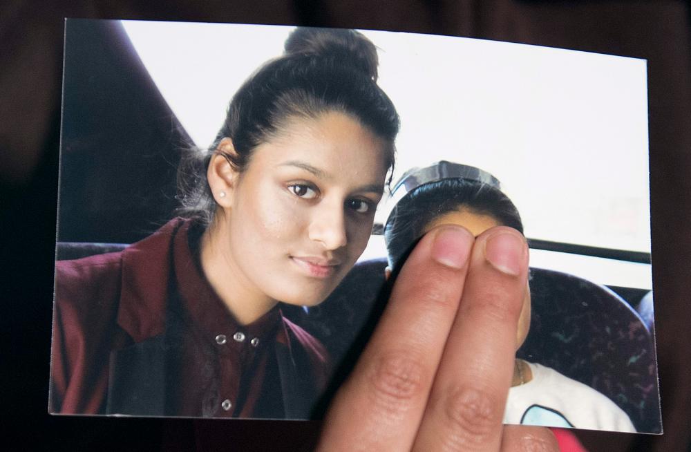 In this file photo taken on Feb 22, 2015 Renu Begum, eldest sister of missing British girl Shamima Begum, holds a picture of her sister while being interviewed by the media in central London. — AFP