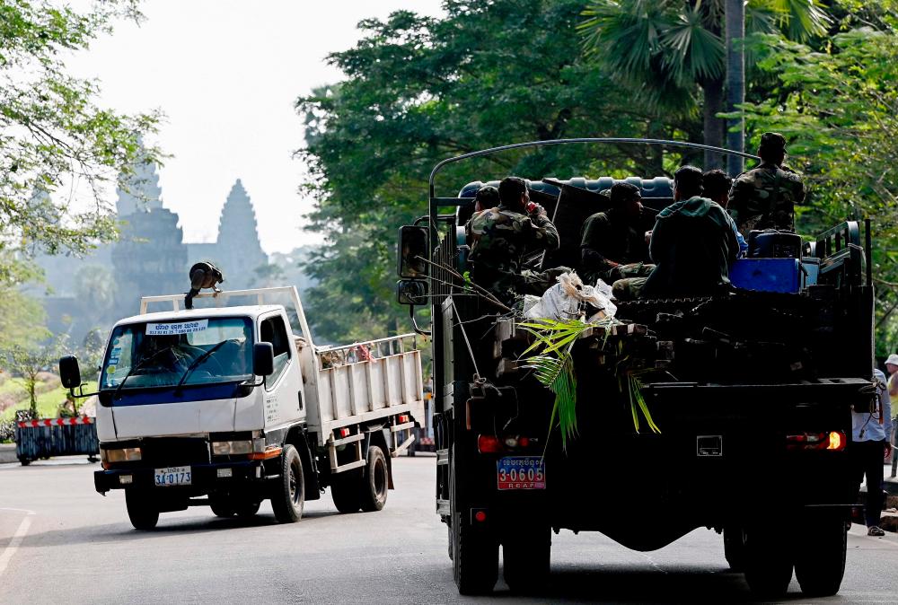 This file photo taken on January 18, 2023 shows a military truck transporting the belongings of a resident past the Angkor Wat temple in Siem Reap province. AFPPIX