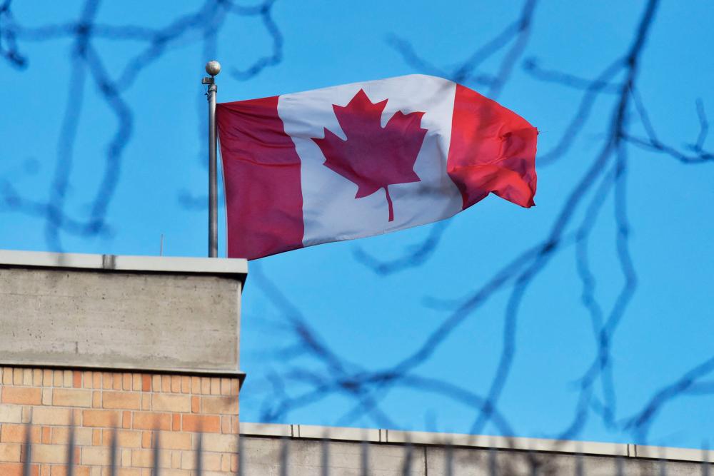 (FILES) In this file photo the Canadian flag flies above the Canadian embassy in Beijing on January 15, 2019. - AFP