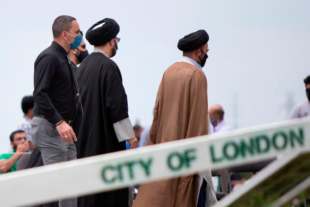 (FILES) In this file photo people arrive at the Islamic Centre of Southwest Ontario on June 12, 2021, to pay their respects at the funeral of four members of the Afzaal Family, in London, Ontario, Canada. Canadian authorities have charged the suspect behind an attack in which a Muslim family was mowed down by a pick-up truck with terrorism, prosecutors said June 14, 2021 in court. – AFP