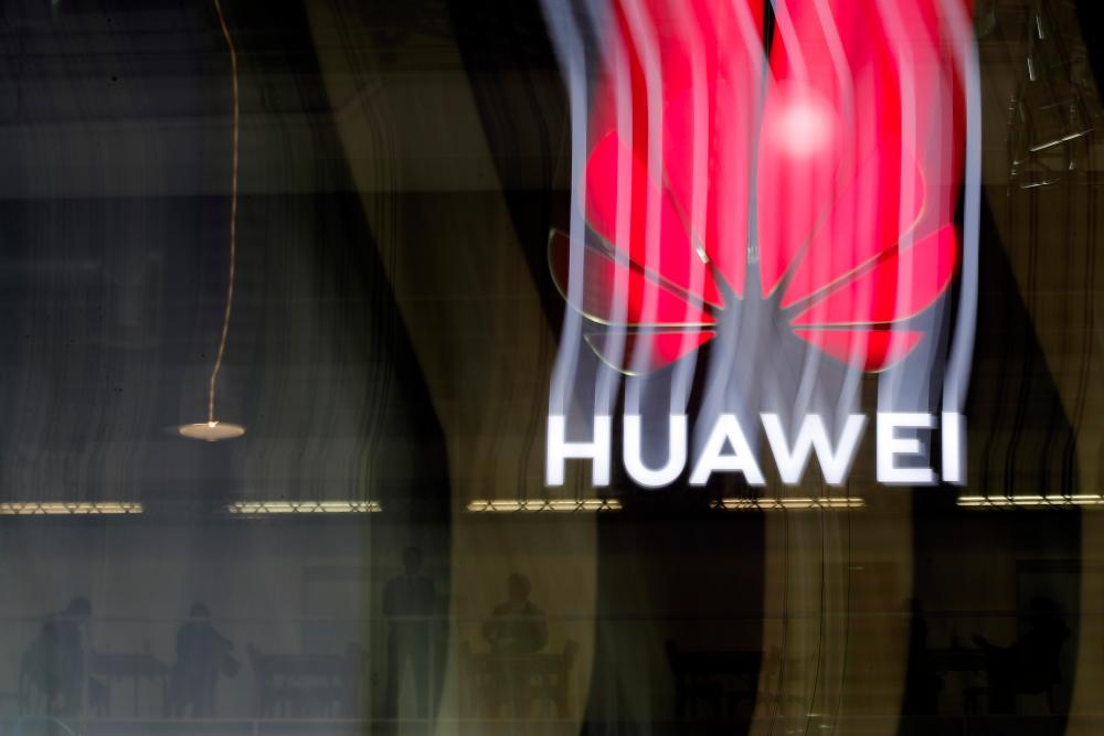 In this file photo taken on Oct 15, an illuminated Huawei sign is on display during the 10th Global mobile broadband forum hosted by Huawei in Zurich. — AFP