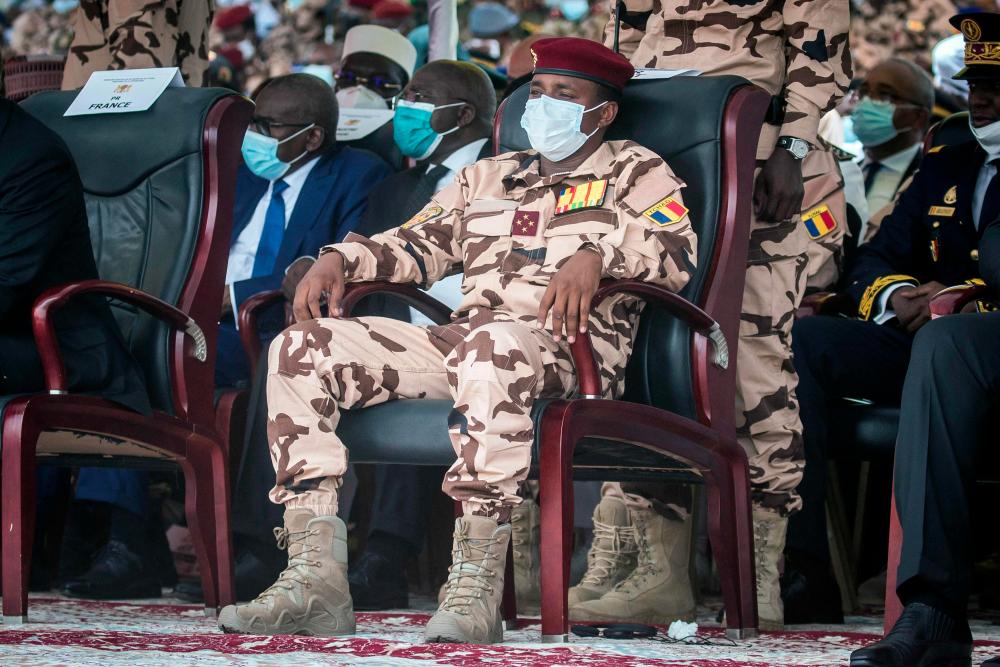(FILES) In this file photo taken on April 23, 2021 Mahamat Idriss Deby (C) sits in the honor tribune during the state funeral for his father Chadian president Idriss Deby in N'Djamena. - AFPPIX