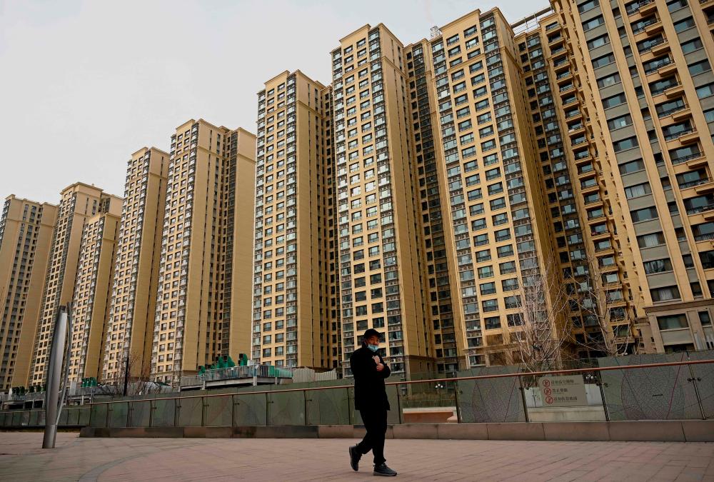 Moody’s says costs to bail out local governments and state firms and control its property crisis would weigh on China’s economy. – AFPpic