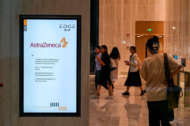 People walk in the access area of the AstraZeneca office in Shanghai - AFPpix