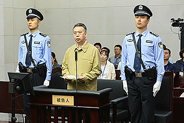 This file handout photo taken on June 20, 2019 and released by the Tianjin No.1 Intermediate Court shows former Interpol chief Meng Hongwei (C) during his trial at the court in the Chinese city of Tianjin — AFP