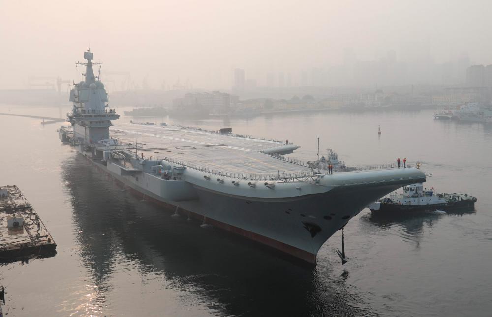 In this file photo taken on May 13, 2018, China's first domestically manufactured aircraft carrier, known only as Type 001A, leaves port in the northeastern city of Dalian. — AFP