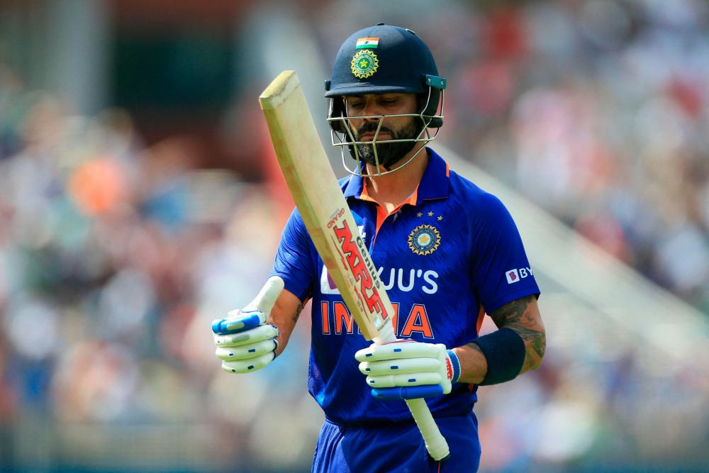 (FILES) In this file photo taken on July 17, 2022 India’s Virat Kohli walks back to the pavilion after losing his wicket during the final one-day international (ODI) cricket match between England and India at Old Trafford in Manchester. AFPPIX