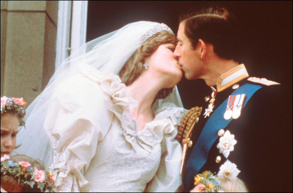 In this file photo taken on July 29, 1981 Charles, Prince of Wales, kisses his bride, Lady Diana, on the balcony of Buckingham Palace when they appeared before a huge crowd after their wedding in St Paul’s Cathedral. The fourth season of Netflix hit “The Crown” has stirred controversy in Britain where its treatment of the heir to the throne, Prince Charles, has been criticised for taking too much artistic license. / AFP / POOL / -