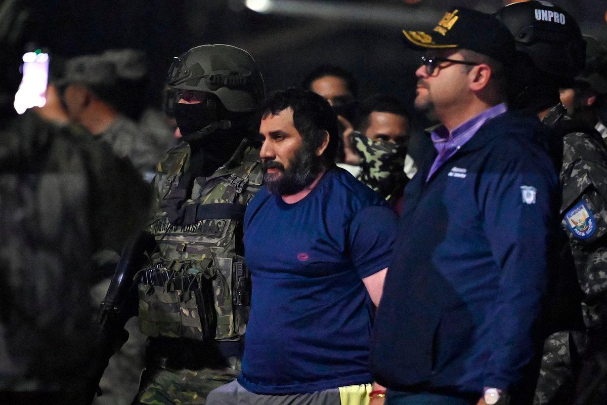 Drug trafficker Adolfo Macias, alias Fito, is guarded by Ecuador’s Interior Minister John Reimberg (R) and military personnel upon arrival at the air base in Guayaquil, Ecuador, on June 25, 2025 - Photo by Marcos PIN / AFP