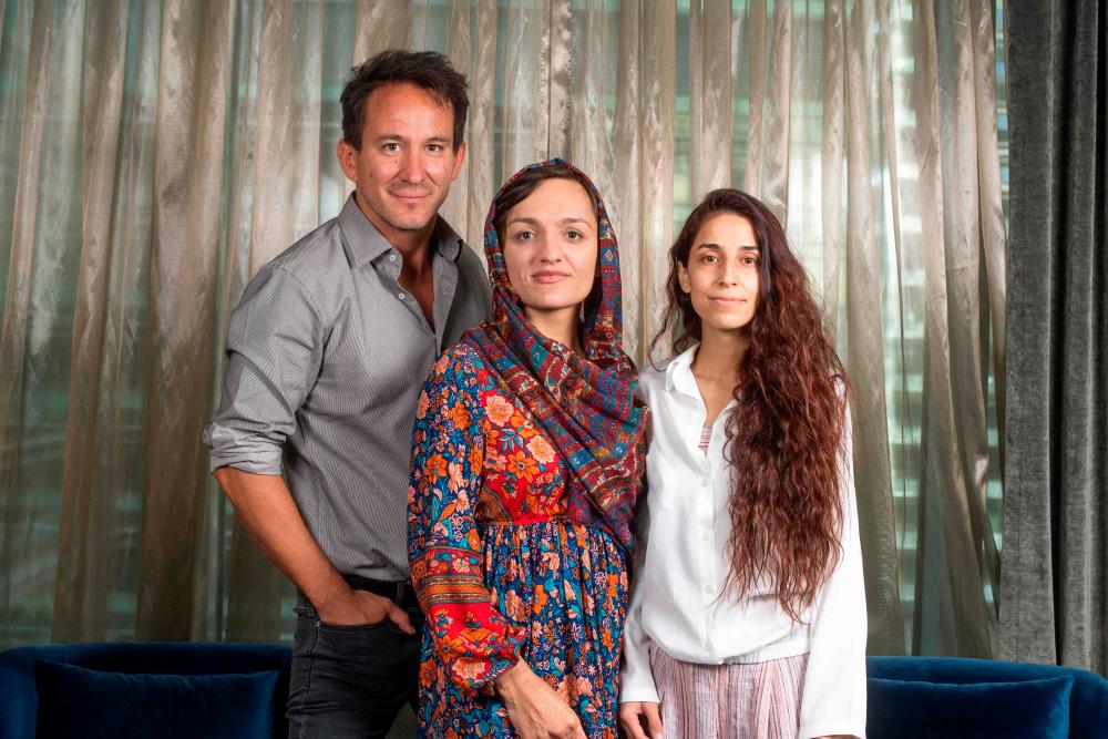 In this file photo taken on September 10, 2022, (L-R) Director Marcel Mettelsiefen, former Mayor of Maidan Shahr, Afghanistan, Zarifa Ghafari and filmmaker Tamana Ayazi pose for AFP during the 2022 Toronto International Film Festival in Toronto, Canada/AFPPix