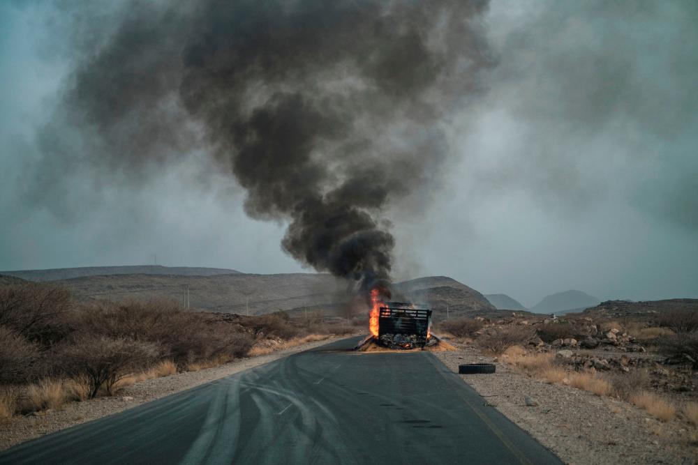 In this file photo taken on June 10, 2022 a truck, carrying grains to Tigray and belonging to the World Food Programme (WFP), burns out on a route 80 kilometers from the Semera, Ethiopia. AFPPIX