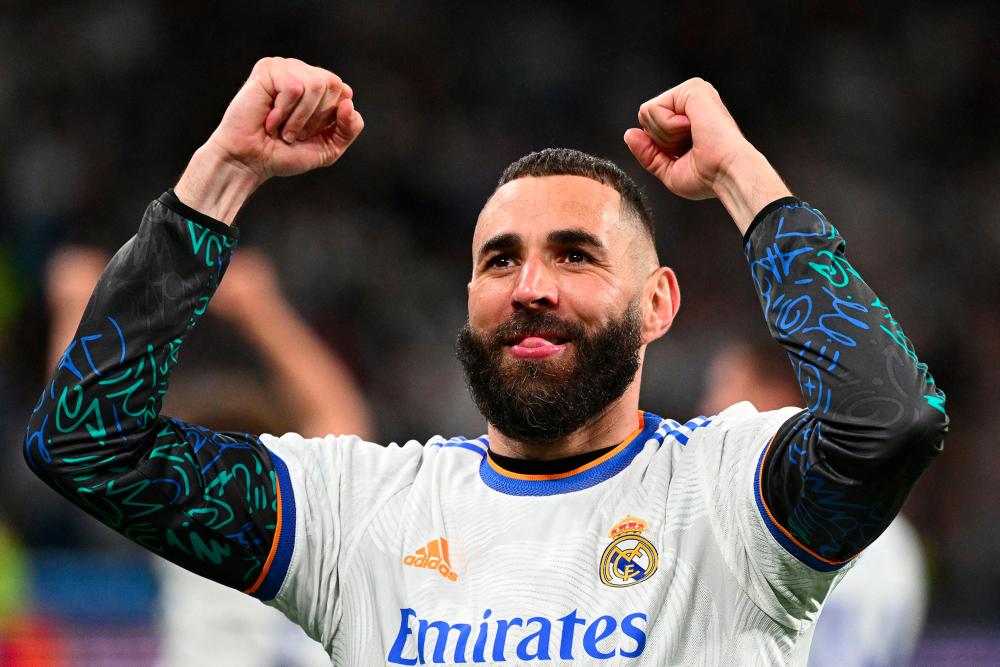 (FILES) In this file photo taken on May 4, 2022 Real Madrid's French forward Karim Benzema celebrates at the end of the UEFA Champions League semi-final second leg football match between Real Madrid CF and Manchester City at the Santiago Bernabeu stadium in Madrid. - AFPPIX