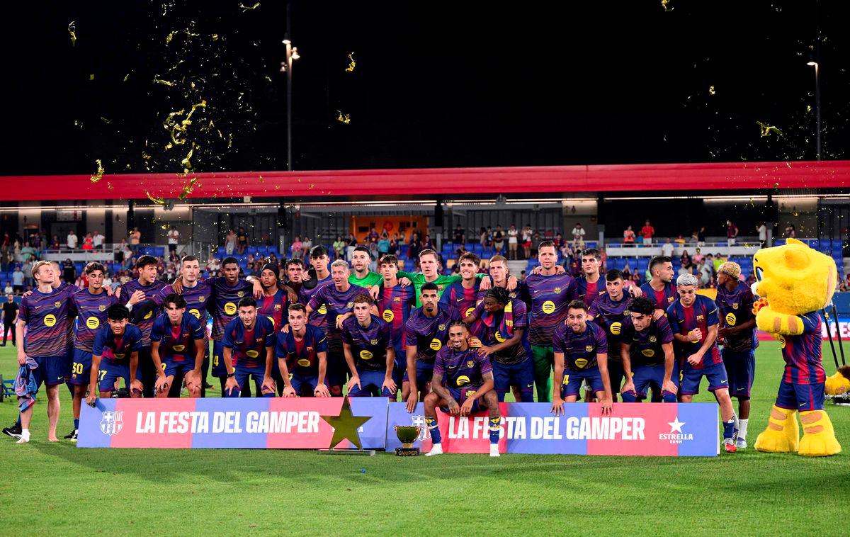 Barcelona players pose with their trophy after winning the 60th Joan Gamper Trophy football match between FC Barcelona and Como 1907 at Johan Cruyff Stadium in Barcelona on August 10, 2025. - AFPPIX
