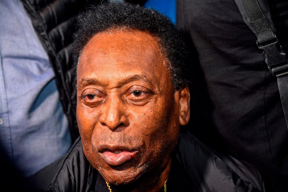 (FILES) In this file photo taken on April 09, 2019 Brazilian football great Edson Arantes do Nascimento, known as Pele, arrives at Guarulhos International Airport, in Guarulhos some 25km from Sao Paulo, Brazil. Brazilian football legend Pele has been hospitalized for treatment of a previously identified colon tumor, his doctors said on November 8, 2021, the latest health problem for the 81-year-old icon. AFPpix