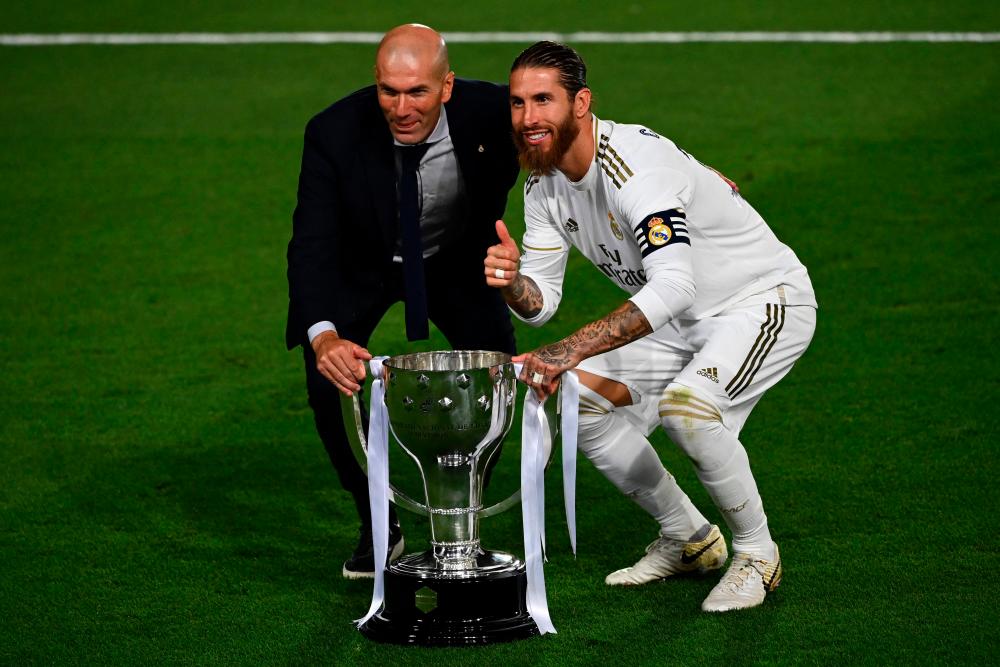 Legendary captain Sergio Ramos (right) seen with coach Zinedine Zidane is to leave Real Madrid after a glittering, trophy-laden career spanning 671 games and 16 seasons, the club announced on June 16, 2021. – AFPPIX