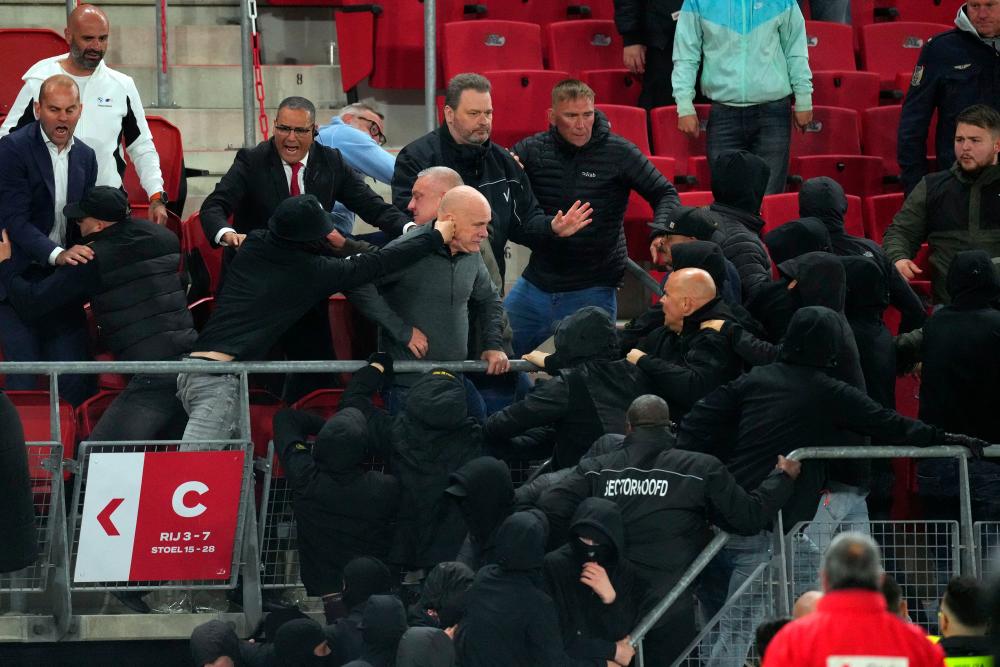 Riots break out between supporters in the stands after the UEFA Conference League semi-final football match between AZ Alkmaar and West Ham United FC at the AFAS stadium, in Alkmaar on May 18, 2023. AFPPIX