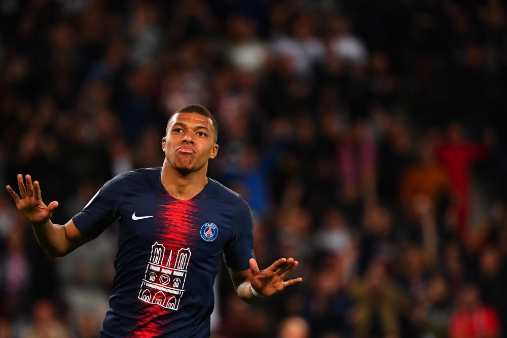 In this file photo taken on April 21, 2019 Paris Saint-Germain's French forward Kylian Mbappe celebrates after scoring his team second goal during the French L1 football match between PSG and Monaco (ASM) at the Parc des Princes stadium in Paris. - AFP