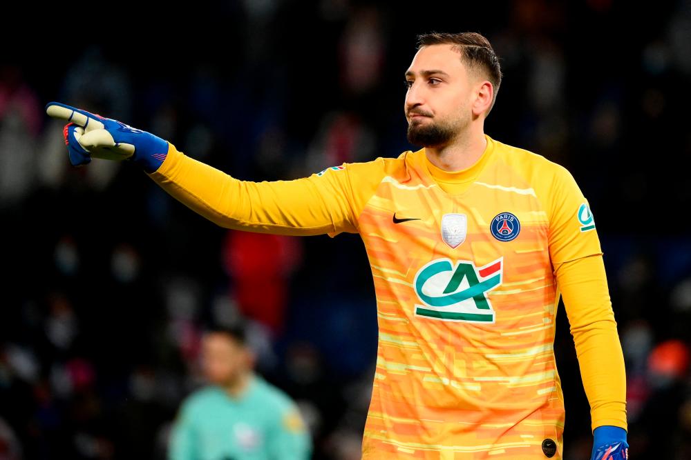 (FILES) January 31, 2022 Paris Saint-Germain’s Italian goalkeeper Gianluigi Donnarumma geatures after saving a goal during the penalty shootout of the French Cup football match against Nice at the Parc des Princes stadium in Paris. AFPPIX