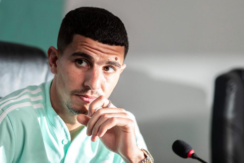 (FILES) A picture taken on January 15, 2022 in Douala shows Algeria's defender Youcef Atal giving a press conference.- AFPPIX