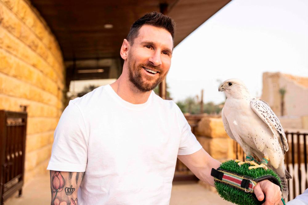 This file handout photo taken on May 01, 2023, and provided by the Saudi Tourism Authority shows Argentina’s forward Lionel Messi holding a falcon in Riyadh. Argentine superstar Lionel Messi will play in Saudi Arabia next season under a blockbuster deal, a source with knowledge of the negotiations told AFP on May 9, 2023/AFPPix