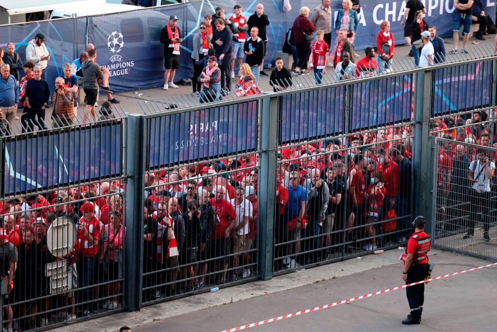 In this file photo taken on May 28, 2022, Liverpool fans stand outside unable to get in in time leading to the match being delayed prior to the UEFA Champions League final football match between Liverpool and Real Madrid at the Stade de France in Saint-Denis, north of Paris. AFPPIX