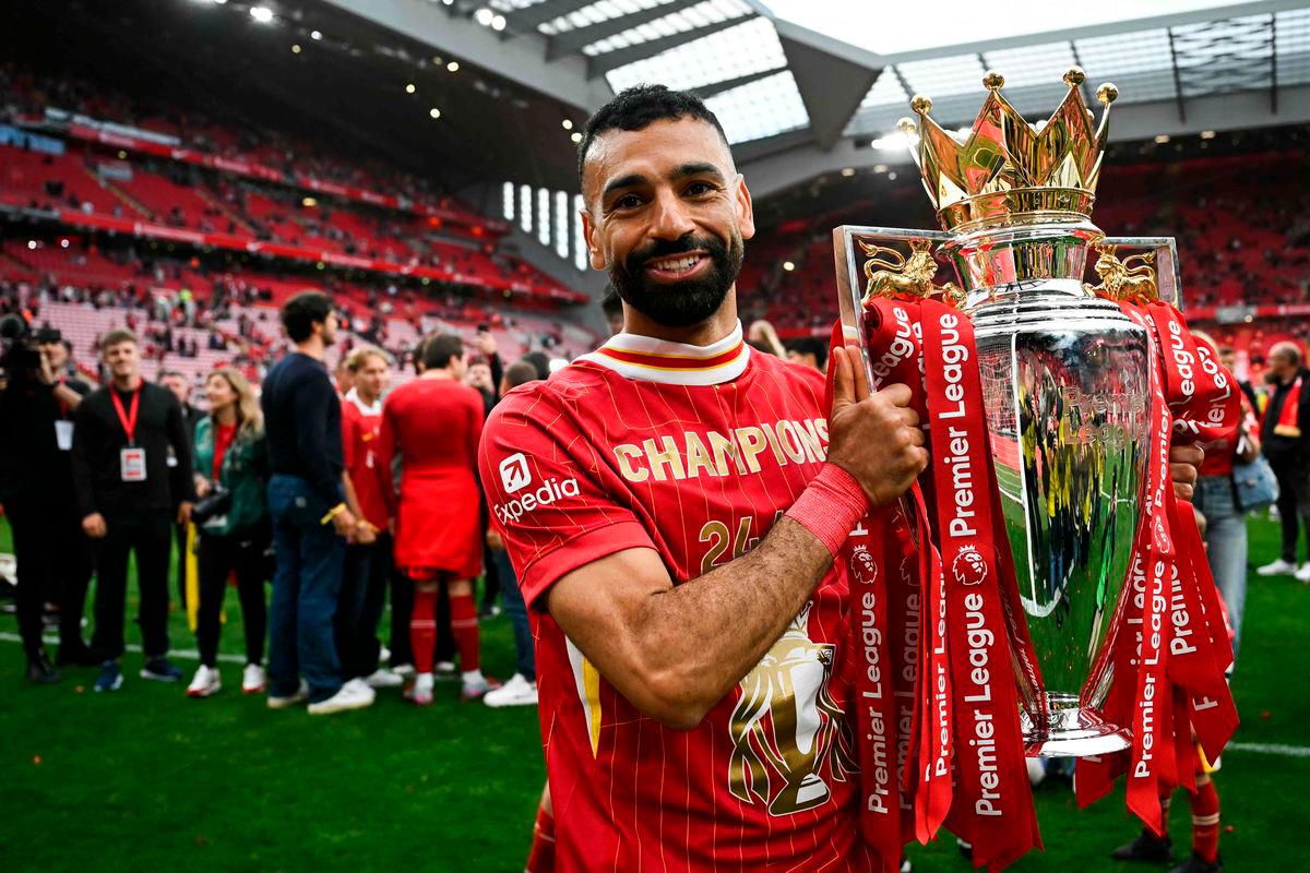 Liverpool’s Egyptian striker #11 Mohamed Salah celebrates with the Premier League trophy at the end of the English Premier League football match between Liverpool and Crystal Palace at Anfield in Liverpool, north west England on May 25, 2025. AFP