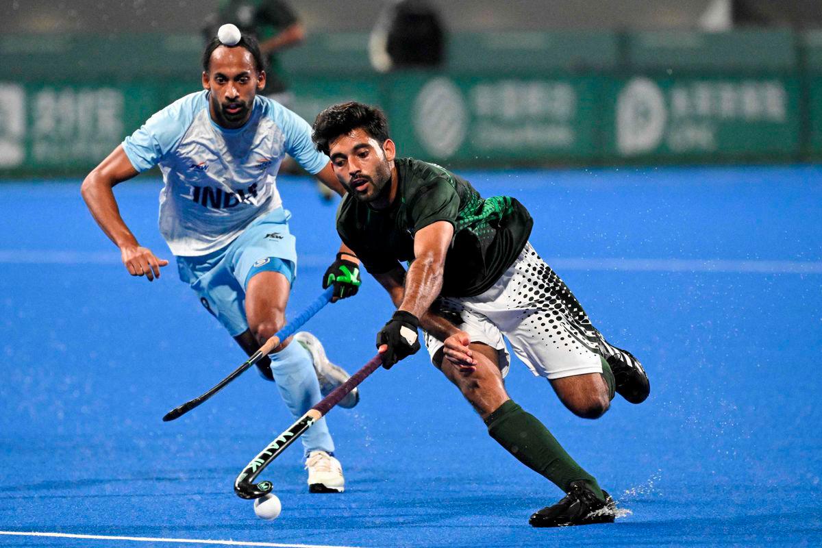 Pakistan's Abdul Waheed Ashraf Rana (R) controls the ball as India's Hardik Singh looks on during the preliminary men's pool hockey match between India and Pakistan at the 2022 Asian Games in Hangzhou in China's eastern Zhejiang province on September 30, 2023. - AFPPIX