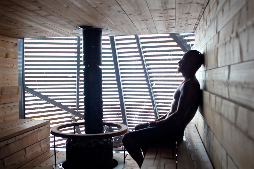 FILES) In this file photo taken on July 07, 2016 Finnish actor Jasper Paakkonen relaxes inside the trendy new boutique sauna called Loyly (Finnish for “Steam”), in Helsinki. The sauna tradition in Finland’s has been inscribed on the UNESCO Lists of Intangible Cultural Heritage on December 17, 2020. AFP / Sam KINGSLEY