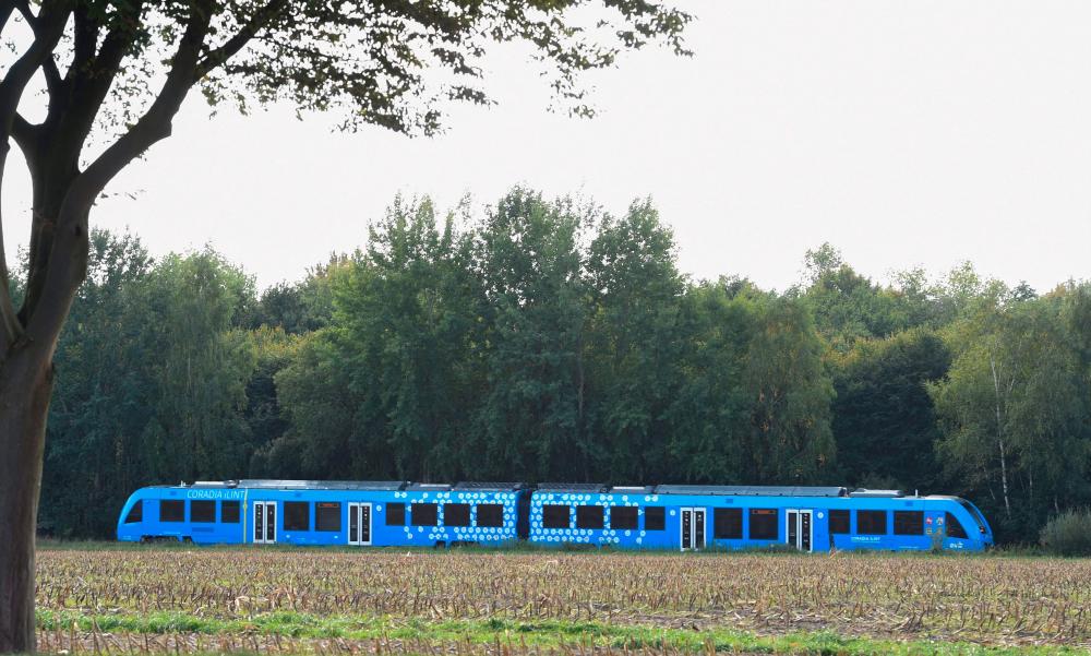 (FILES) In this file photo taken on September 16, 2018 A hydrogen-powered train, by French train maker Alstom, drives near Bremervoerde, Germany, as it enters service on September 16, 2018. Germany inaugurates a rail line running entirely on hydrogen on August 24, 2022 - AFPPIX