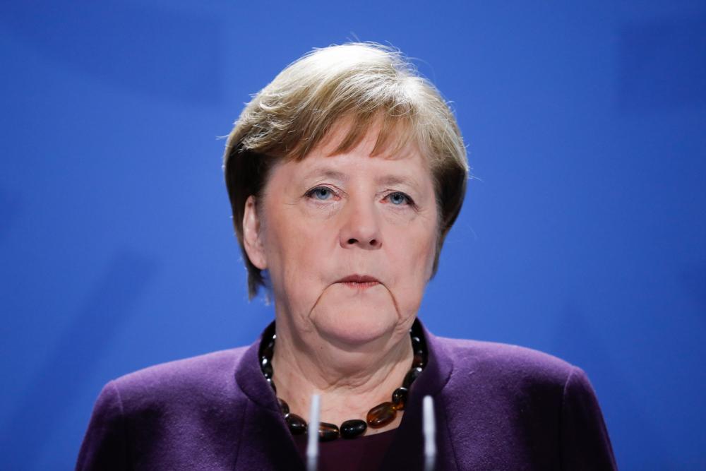 Germany’s Merkel returns to office after quarantine stint