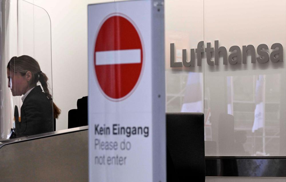 A stop sign stands in the check-in area of German airline Lufthansa during a strike action by ground crews, services staff and security personnel, at Frankfurt’s International Airport, western Germany, on early February 20, 2024/AFPPix
