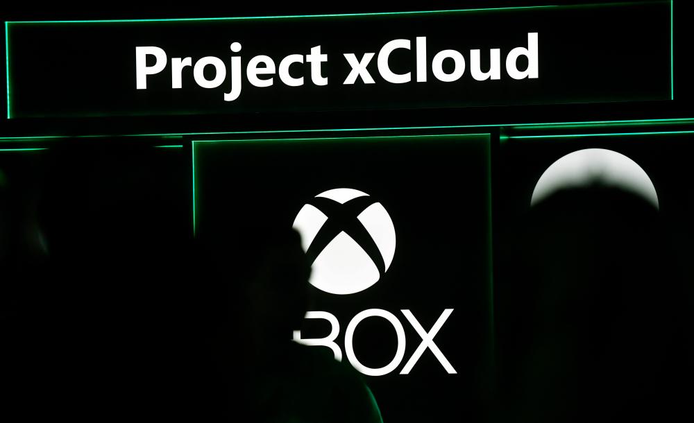 In this file photo taken on August 20, 2019 the logo of “Project xCloud” is pictured at the stand of Xbox during the media day of the Gamescom video games trade fair in Cologne, western Germany. Microsoft said on July 16, 2020 that its cloud video game service will debut in September as a feature available to Xbox Game Pass Ultimate subscribers. / AFP / Ina FASSBENDER