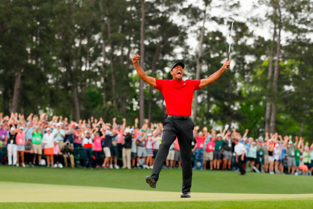 (FILES) In this file photo taken on April 14, 2019 American golfer Tiger Woods celebrates after sinking his putt on the 18th green to win during the final round of the Masters at Augusta National Golf Club in Augusta, Georgia. Tiger Woods has ruled out making a full-time return to professional golf as he works his way back from career-threatening leg injuries. AFPpix