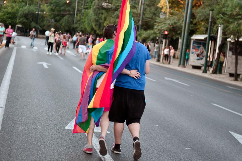Participants hug and kiss in Athens during the annual Gay Pride parade on June 14, 2014. - AFPPIX