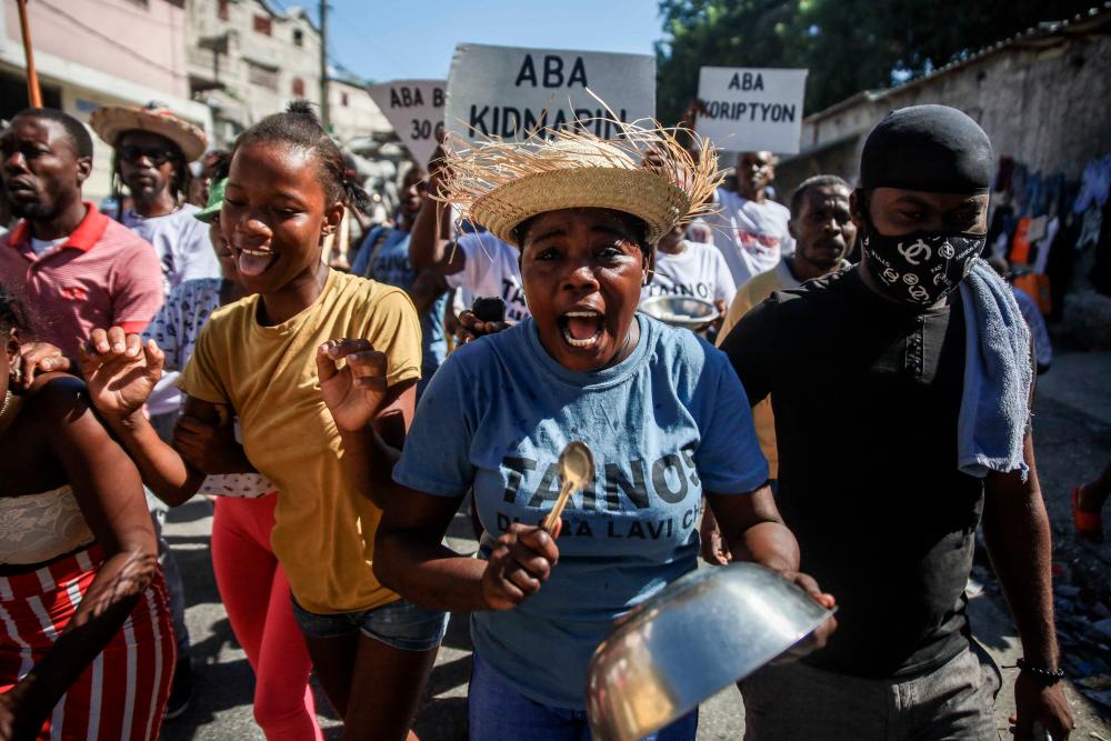 In this file photo taken on November 18, 2021, People protest against the country’s spike in kidnappings and gang-aggravated fuel crisis, on the day marking the 218th anniversary of the Battle of Vertières, the historic victory against France, in Port-au-Prince, Haiti/AFPPix