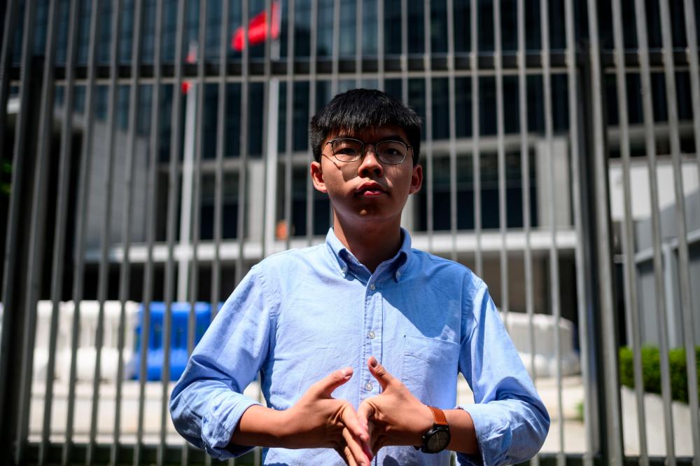 In this file photo taken on Sept 28, 2019, pro-democracy activist and South Horizons Community Organiser Joshua Wong stands in front of the Central Government Complex before the announcement of his run for 2019 District Council elections in Hong Kong. — AFP